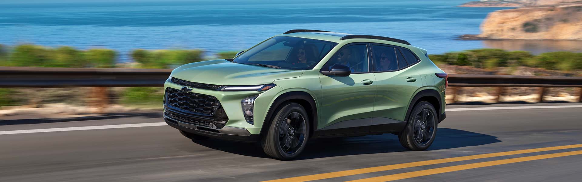 A 2024 Chevrolet Trax driving along a scenic road